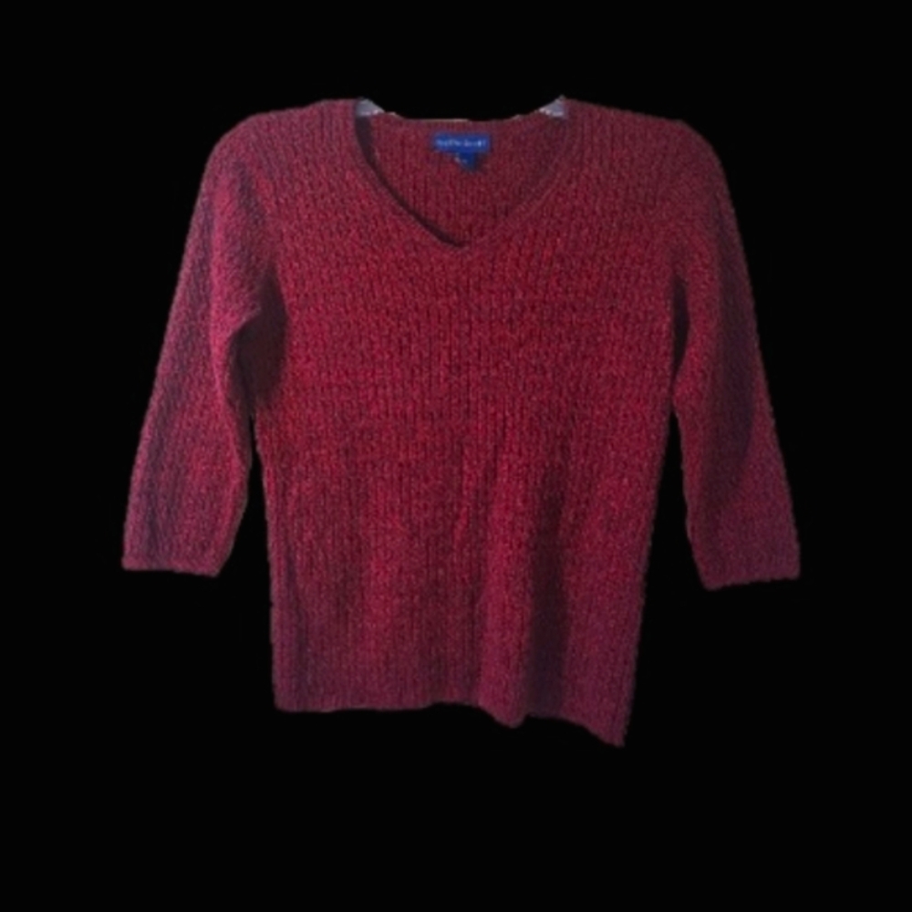 Deep red cable knit sweater.